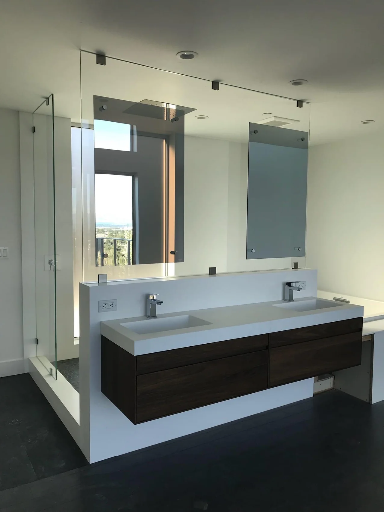 Custom vanity mirrors mounted above a modern double sink